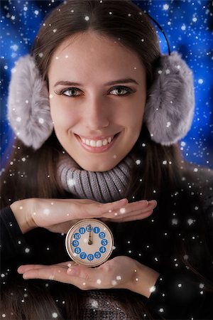 Beautiful girl holding a clock with snow falling around her. Stock Photo - Budget Royalty-Free & Subscription, Code: 400-07251553