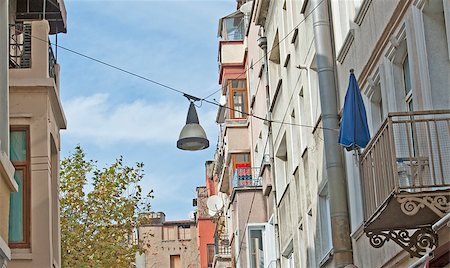 Building exteriors of city center apartment blocks on a narrow street with basic street lamp Fotografie stock - Microstock e Abbonamento, Codice: 400-07252033