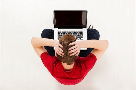 simsearch:400-05209351,k - Young man sitting in the floor and working with a laptop, worried with something Stock Photo - Budget Royalty-Free & Subscription, Code: 400-07252269