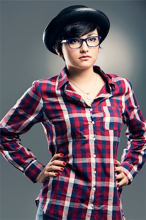 funny looking girls with glasses - Beautiful girl with a funny face wearing a hat and nerd glasses, isolated over white background Stock Photo - Budget Royalty-Free & Subscription, Code: 400-07252306