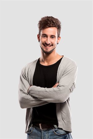 simsearch:400-05912369,k - Handsome young man with hands folded, over a gray background Fotografie stock - Microstock e Abbonamento, Codice: 400-07252315