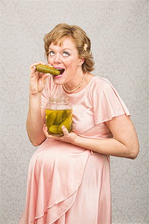 simsearch:400-07252384,k - Overjoyed pregnant female eating from a jar of pickles Photographie de stock - Aubaine LD & Abonnement, Code: 400-07252378