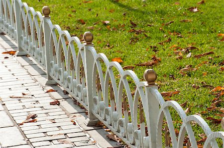 paulvinten (artist) - Small white metal border fence at the edge of grass and path in park Stockbilder - Microstock & Abonnement, Bildnummer: 400-07253875