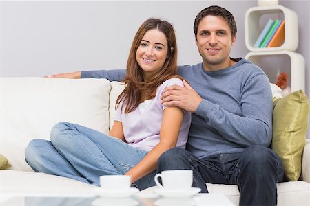 simsearch:6109-07601570,k - Portrait of a cute relaxed young couple sitting on sofa at home Stockbilder - Microstock & Abonnement, Bildnummer: 400-07266796