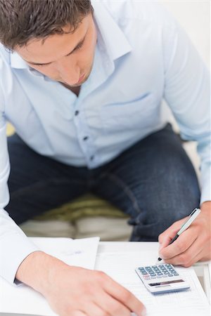 simsearch:400-07333928,k - Close-up of a young man with bills and calculator at the table Stock Photo - Budget Royalty-Free & Subscription, Code: 400-07266851