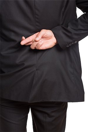 simsearch:400-07274414,k - Close-up mid section of a businessman with crossed fingers over white background Photographie de stock - Aubaine LD & Abonnement, Code: 400-07266991