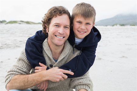 simsearch:400-07267212,k - Portrait of a happy man piggybacking his cheerful son at the beach Stockbilder - Microstock & Abonnement, Bildnummer: 400-07267104