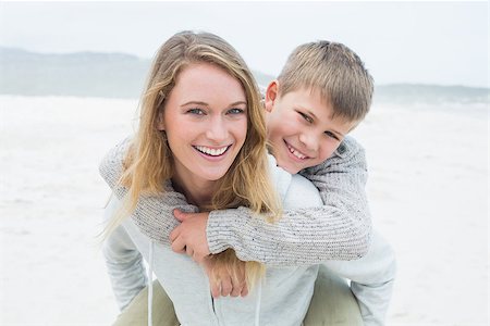 simsearch:400-07267212,k - Portrait of a happy woman piggybacking her cheerful son at the beach Stockbilder - Microstock & Abonnement, Bildnummer: 400-07267194