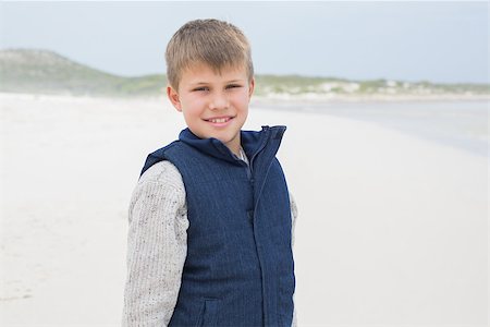 Portrait of a cute smiling young boy standing at the beach Stock Photo - Budget Royalty-Free & Subscription, Code: 400-07267231