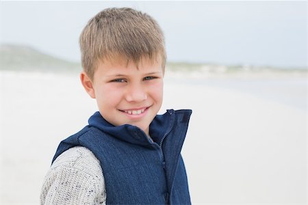 Close-up portrait of a cute smiling young boy standing at the beach Stock Photo - Budget Royalty-Free & Subscription, Code: 400-07267233