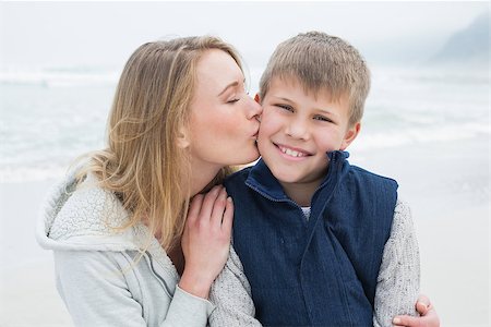 simsearch:400-07267308,k - Mother kissing cute young boy at the beach Fotografie stock - Microstock e Abbonamento, Codice: 400-07267255