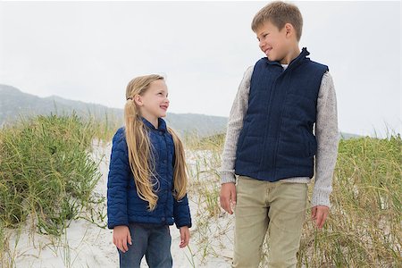 simsearch:400-07267308,k - Low angle view of a happy brother and sister standing at the beach Fotografie stock - Microstock e Abbonamento, Codice: 400-07267288