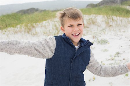 simsearch:400-07267212,k - Portrait of a cheerful young boy running at the beach Stockbilder - Microstock & Abonnement, Bildnummer: 400-07267297