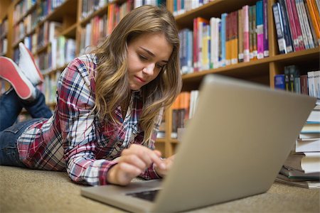 simsearch:400-07267769,k - Young happy student lying on library floor using laptop in college Stock Photo - Budget Royalty-Free & Subscription, Code: 400-07267510