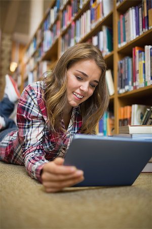 simsearch:400-07141917,k - Young student lying on library floor using tablet in college Stock Photo - Budget Royalty-Free & Subscription, Code: 400-07267522