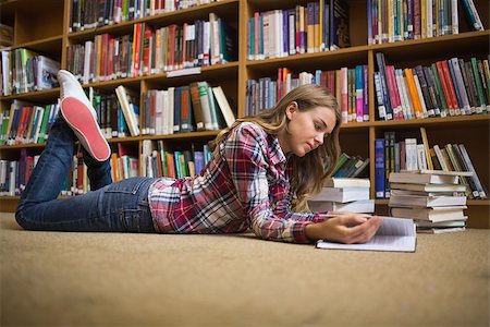 simsearch:400-07141917,k - Young student lying on library floor reading in college Stock Photo - Budget Royalty-Free & Subscription, Code: 400-07267531