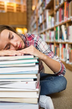 simsearch:400-07141917,k - Dozing young student sitting on library floor leaning on pile of books in college Stock Photo - Budget Royalty-Free & Subscription, Code: 400-07267551