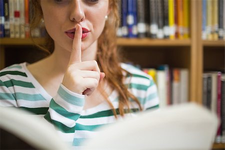 simsearch:400-07267769,k - Redhead student asking for silence holding a book at the university Stock Photo - Budget Royalty-Free & Subscription, Code: 400-07267610