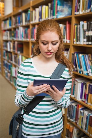 simsearch:400-07267769,k - Redhead student using tablet standing in library at the university Stock Photo - Budget Royalty-Free & Subscription, Code: 400-07267644