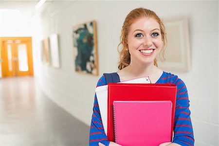 simsearch:400-07267769,k - Smiling student holding folders in the hall at the university Stock Photo - Budget Royalty-Free & Subscription, Code: 400-07267680