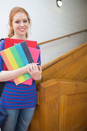 simsearch:400-07267769,k - Pretty student standing on the stairs smiling at camera at the university Stock Photo - Budget Royalty-Free & Subscription, Code: 400-07267707