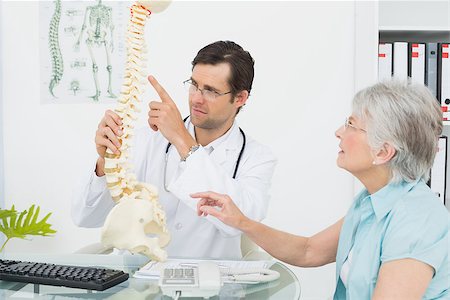 Male doctor explaining the spine to a senior patient in medical office Stock Photo - Budget Royalty-Free & Subscription, Code: 400-07267734