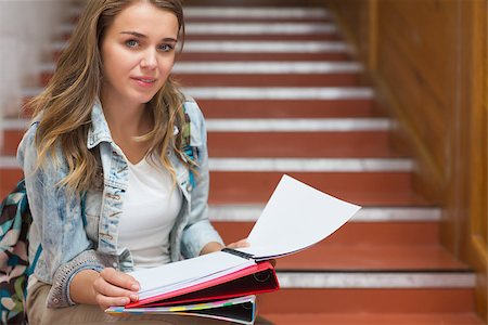 simsearch:400-07267769,k - Smiling young student sitting on stairs looking at camera in college Stock Photo - Budget Royalty-Free & Subscription, Code: 400-07267746