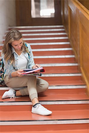 simsearch:400-07267769,k - Pretty young student sitting on stairs looking at camera in college Stock Photo - Budget Royalty-Free & Subscription, Code: 400-07267742