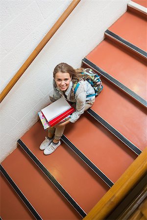 simsearch:400-07267769,k - Young student sitting on stairs smiling up at camera in college Stock Photo - Budget Royalty-Free & Subscription, Code: 400-07267757