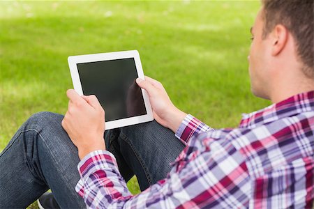 students tablets outside - Happy student using his tablet outside on college campus Stock Photo - Budget Royalty-Free & Subscription, Code: 400-07267788