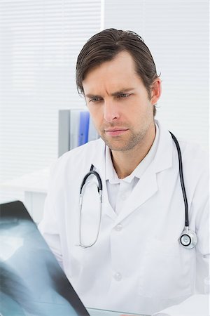 simsearch:400-07269250,k - Concentrated male doctor looking at x-ray picture of lungs in the medical office Stock Photo - Budget Royalty-Free & Subscription, Code: 400-07267810