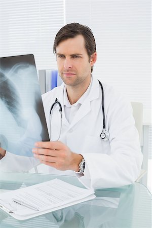 simsearch:400-07269250,k - Concentrated male doctor looking at x-ray picture of lungs in the medical office Stock Photo - Budget Royalty-Free & Subscription, Code: 400-07267812