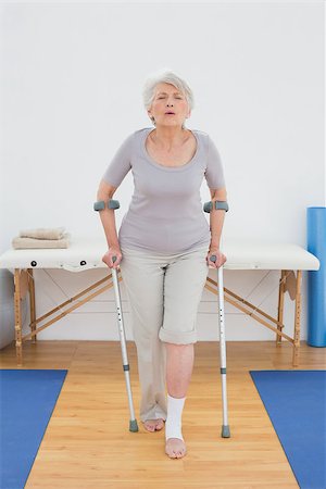 disabled women on crutches - Full length of a senior woman with crutches walking in the hospital gym Stock Photo - Budget Royalty-Free & Subscription, Code: 400-07267828