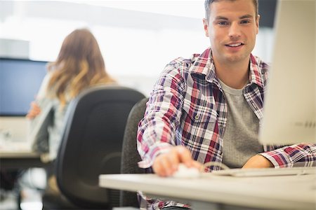 simsearch:400-07267978,k - Cheerful student looking at camera in the computer room in college Stock Photo - Budget Royalty-Free & Subscription, Code: 400-07267942