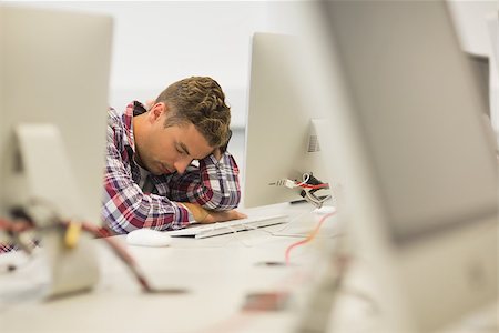 simsearch:400-07267978,k - Stressed handsome student studying in the computer room in college Stock Photo - Budget Royalty-Free & Subscription, Code: 400-07267967