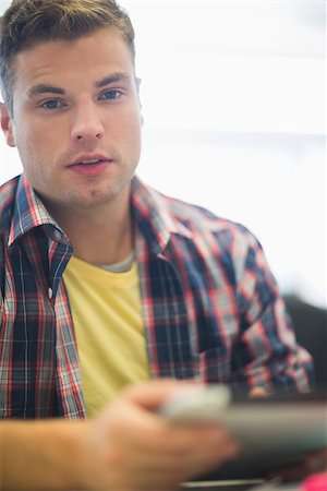 simsearch:400-07267978,k - Handsome student working in the computer room looking at camera in college Stock Photo - Budget Royalty-Free & Subscription, Code: 400-07268017