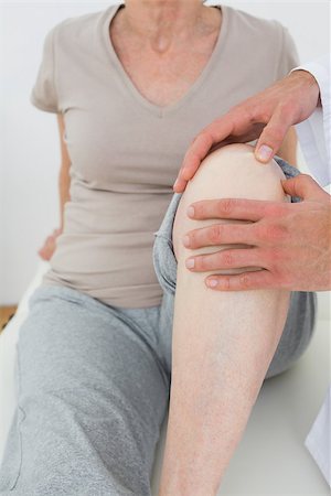 Mid section of a woman getting her knee examined at the medical office Stock Photo - Budget Royalty-Free & Subscription, Code: 400-07268032