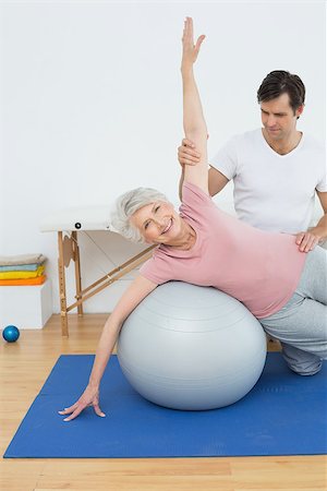 Physical therapist assisting senior woman with yoga ball in the gym at hospital Stock Photo - Budget Royalty-Free & Subscription, Code: 400-07268112