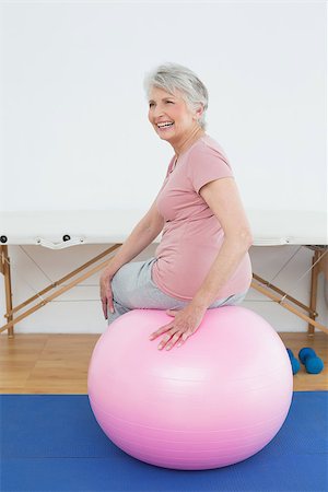 Rear view portrait of a senior woman sitting on yoga ball in the gym at hospital Stock Photo - Budget Royalty-Free & Subscription, Code: 400-07268120