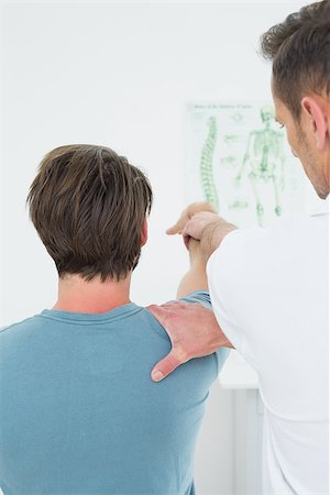 simsearch:400-04337005,k - Rear view of a male physiotherapist stretching a young man's arm in the medical office Foto de stock - Super Valor sin royalties y Suscripción, Código: 400-07269561