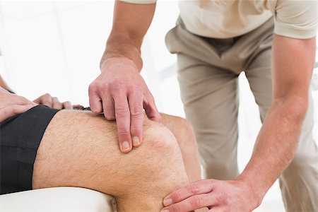 Close-up mid section of a young man getting his knee examined at the medical office Stock Photo - Budget Royalty-Free & Subscription, Code: 400-07269687