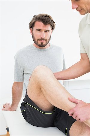 Portrait of a young man getting his knee examined at the medical office Stock Photo - Budget Royalty-Free & Subscription, Code: 400-07269699