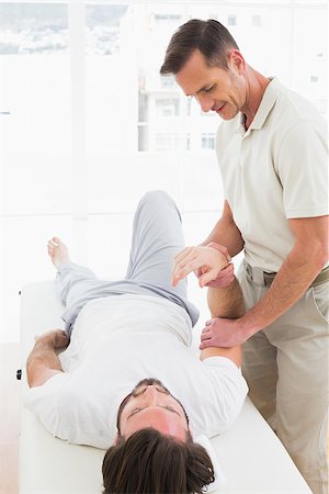 simsearch:400-04337005,k - Male physiotherapist examining a young man's hand in the medical office Foto de stock - Super Valor sin royalties y Suscripción, Código: 400-07269810