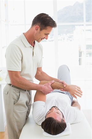 simsearch:400-04337005,k - Male physiotherapist examining a young man's hand in the medical office Foto de stock - Super Valor sin royalties y Suscripción, Código: 400-07269813