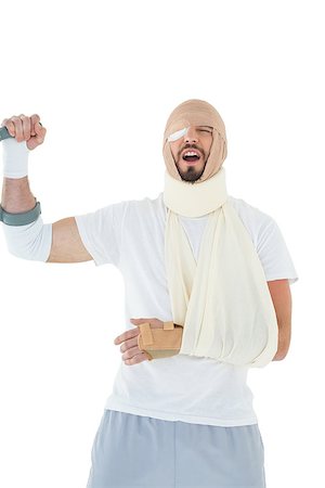 simsearch:400-04255649,k - Cheerful young man with broken hand cheering over  white background Foto de stock - Royalty-Free Super Valor e Assinatura, Número: 400-07269919