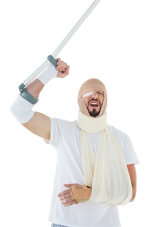 Cheerful young man with broken hand and crutch cheering over  white background Stock Photo - Budget Royalty-Free & Subscription, Code: 400-07269913