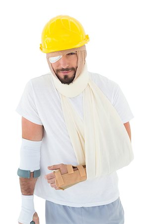 simsearch:400-04422230,k - Portrait of a young man in hard hat with broken hand and crutch over  white background Stock Photo - Budget Royalty-Free & Subscription, Code: 400-07269945