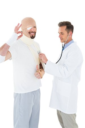 Side view of a doctor auscultating a patient tied up in bandage with stethoscope over  white background Stock Photo - Budget Royalty-Free & Subscription, Code: 400-07269958