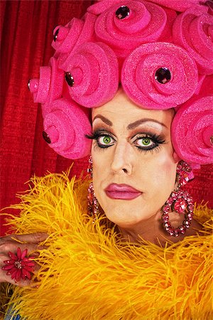 simsearch:400-07261849,k - Serious man in yellow boa and pink floral wig Fotografie stock - Microstock e Abbonamento, Codice: 400-07261848