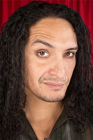 simsearch:400-07042108,k - Close up of skeptical Latino man with long hair Stock Photo - Budget Royalty-Free & Subscription, Code: 400-07262296